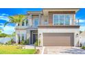 Beautiful two-story modern home featuring clean lines, balcony, lush landscaping, and an attached two-car garage at 1805 Goldenrod St, Sarasota, FL 34239