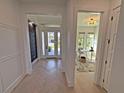 Bright foyer with herringbone wood floors, an office, and the front door at 1805 Goldenrod St, Sarasota, FL 34239