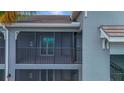 Screened balcony with metal railing and sliding glass door at 12520 Galapagos Ct # 207, Venice, FL 34293