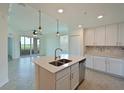 Modern kitchen with island, stainless steel appliances, and water views at 1020 Tidewater Shores Loop # 108, Bradenton, FL 34208