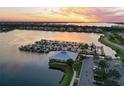 Sunset view of marina with many boats and clubhouse at 1020 Tidewater Shores Loop # 108, Bradenton, FL 34208