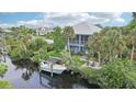 Stunning home with a private boat dock, lush greenery, and a tranquil waterfront setting at 9033 Allapata Ln, Venice, FL 34293