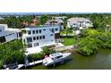 Luxury waterfront home with private dock, boat, and lush landscaping at 1406 Tangier Way, Sarasota, FL 34239