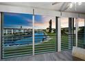 Balcony with sliding glass doors offers stunning sunset views over the canal at 4350 Chatham Dr # E307, Longboat Key, FL 34228