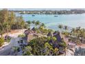 Aerial view showcasing waterfront property with tropical landscaping at 7147 La Lenaire Dr, Longboat Key, FL 34228