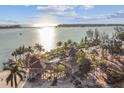 Aerial view of waterfront home with private dock and lush landscaping at 7147 La Lenaire Dr, Longboat Key, FL 34228