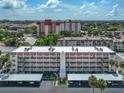 Aerial view of condo building, showcasing parking and landscaping at 220 Santa Maria St # 240, Venice, FL 34285