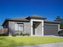 Modern one-story home with gray brick exterior and two-car garage at 5314 Arley Road, North Port, FL 34288