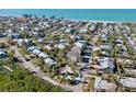 Coastal home aerial view near the beach with tropical landscaping and neighborhood charm at 8010 Marina Dr, Holmes Beach, FL 34217