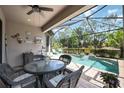 Relaxing screened-in pool area with patio furniture at 13202 Torresina Ter, Bradenton, FL 34211