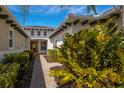 Brick pathway to covered entry with lush landscaping at 5209 Lake Overlook Ave, Bradenton, FL 34208