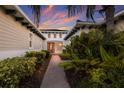 Brick pathway to covered entry with lush landscaping at 5209 Lake Overlook Ave, Bradenton, FL 34208