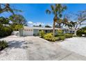 Single-story home featuring well-maintained front yard and a concrete driveway leading to a two-car garage at 506 69Th St, Holmes Beach, FL 34217