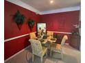 Charming dining room with glass table and red walls at 5146 Northridge Rd # 201, Sarasota, FL 34238