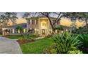 Charming brick home with a lush green lawn, tasteful landscaping, and a welcoming front entrance at 6722 Oakmont Way, Lakewood Ranch, FL 34202