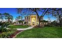 Charming two-story home with brick facade, grand entrance, manicured lawn, and mature trees at 6722 Oakmont Way, Lakewood Ranch, FL 34202