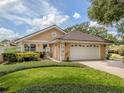 Single story home with a two-car garage and lush landscaping at 424 Cardiff Rd # 27, Venice, FL 34293