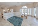 Spacious living room with tiled floors, white couch and large windows at 424 Cardiff Rd # 27, Venice, FL 34293