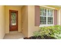 House exterior with red door and brown shutters at 11415 52Nd E Ct, Parrish, FL 34219