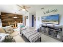 Cozy living room with wood accent wall, comfy seating, and large TV at 21874 Hernando Ave, Port Charlotte, FL 33952