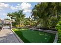 Beautiful backyard putting green with lush landscaping at 4343 Pompano Ln, Palmetto, FL 34221