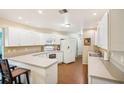 Efficient kitchen featuring white cabinets and a U-shaped counter at 907 E Rosedale Rd, Venice, FL 34293