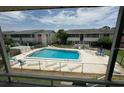 Aerial view of community pool and building at 2501 Beneva Rd # 8, Sarasota, FL 34232