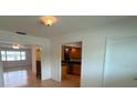 View of living room and kitchen from entryway at 2501 Beneva Rd # 8, Sarasota, FL 34232