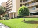 Exterior view of a light beige multi-story building with landscaping at 4410 Fairways Blvd # 602, Bradenton, FL 34209