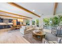 Bright living room with exposed beams and sliding glass doors at 108 Tern Dr, Anna Maria, FL 34216
