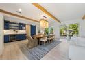 Open concept dining area with exposed beams and wooden table at 108 Tern Dr, Anna Maria, FL 34216
