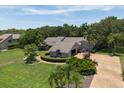 An aerial view of a landscaped single-Gathering home with mature trees and long driveway at 4714 Elder Berry Dr, Sarasota, FL 34241