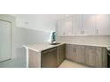 Modern kitchen with wood cabinets, stainless steel appliances, and a quartz island at 1558 4Th St # 210, Sarasota, FL 34236