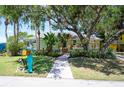 Light green house with mature landscaping and unique mailbox at 5116 Admiral Pl, Sarasota, FL 34231