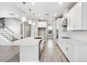 Bright, open kitchen featuring an island, stainless steel appliances, and elegant pendant lights at 7016 Foxboro Way, Nokomis, FL 34275