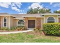 Welcoming front entrance with a pathway, beautiful landscaping, and decorative brick accents creating a warm first impression at 4709 Foy Pl, Sarasota, FL 34243