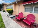 Relaxing patio area with red Adirondack chairs at 4419 Muirfield Dr, Bradenton, FL 34210