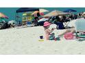 Beach scene with playing in sand; nearby beachgoers and lifeguard at 191 Palm Air Dr, Osprey, FL 34229