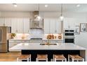 Modern kitchen with white cabinets, quartz countertops and island at 725 Anegada Ln, Sarasota, FL 34234