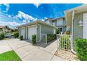 Two-car garage with lush landscaping, inviting entryway to condo at 2002 Bal Harbor Blvd # 1311, Punta Gorda, FL 33950