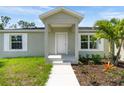 New home with front porch and walkway leading to front door at 12154 Van Loon Ave, Port Charlotte, FL 33981