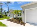 New home with walkway leading to front door and nicely landscaped at 12154 Van Loon Ave, Port Charlotte, FL 33981