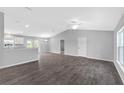 Open concept living room with high ceilings and wood-look tile floors at 12154 Van Loon Ave, Port Charlotte, FL 33981