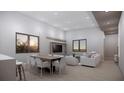 Spacious room with modern decor, a dining area, and a large television at 2344 Bay W St, Sarasota, FL 34237