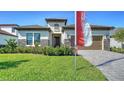 Beautiful home exterior with a well-maintained lawn and attractive stone accents at 429 Alberata Way, Nokomis, FL 34275