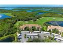 A beautiful condo community overlooks the golf course and bay, enhanced by lush landscaping and covered parking at 7607 Grand Estuary Trl # 205, Bradenton, FL 34212