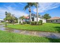 House exterior showcasing a Mediterranean style with lush landscaping at 5201 Highbury Cir, Sarasota, FL 34238