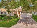 Well-maintained home with a tile roof, attached garage, and a lush green lawn at 4145 Reflections Pkwy, Sarasota, FL 34233