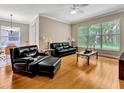 Cozy living room with hardwood floors, comfortable seating, and a large window offering natural light at 4145 Reflections Pkwy, Sarasota, FL 34233