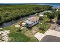 Aerial view of waterfront property with home and shed at 14564 Frizzell Rd, Port Charlotte, FL 33953